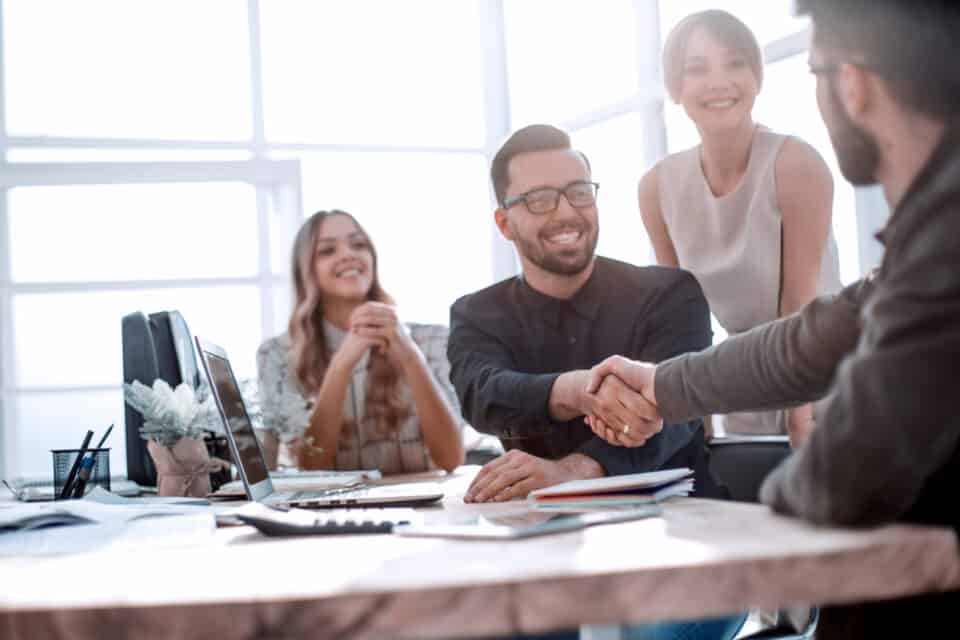 background image of the handshake of business partners in the office. business concept