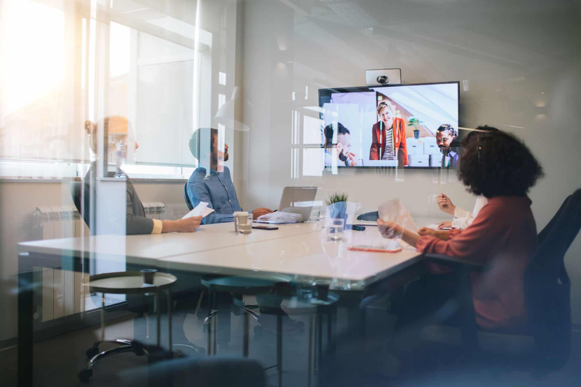 Group of young business people discussing with colleagues on video conference on meeting.