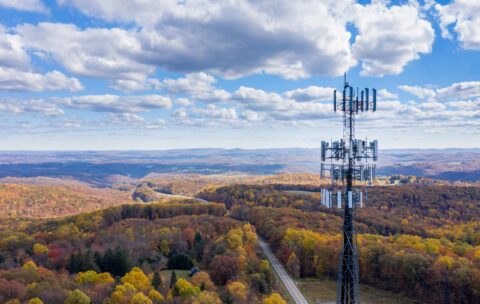 Aerial view of mobiel phone cell tower over forested rural area of West Virginia to illustrate lack of broadband internet service